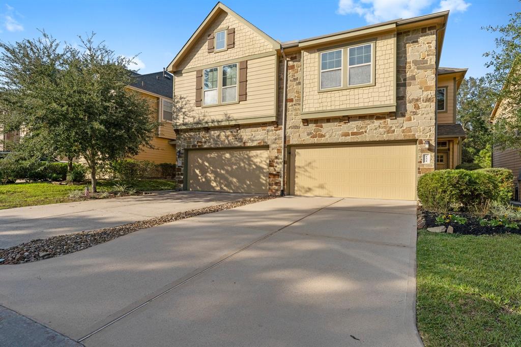 a front view of a house with a yard and a garage