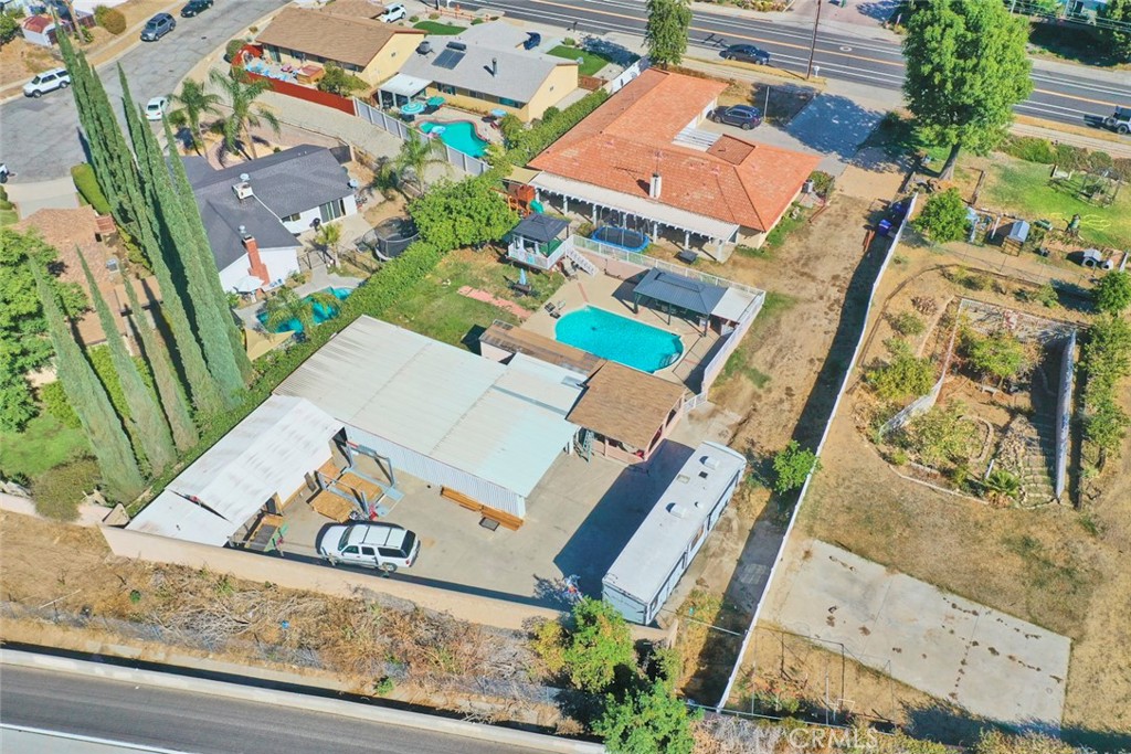 an aerial view of a house with a garden and mountain view