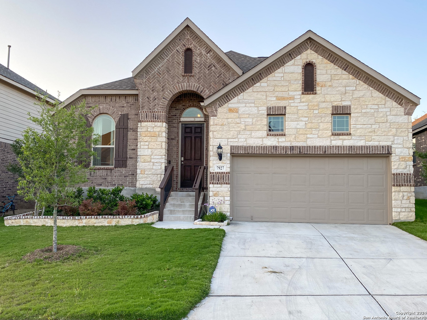 a front view of a house with a yard and garage