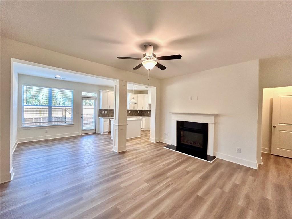 a view of an empty room with a fireplace and a window