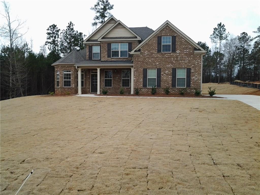 a front view of a house with yard