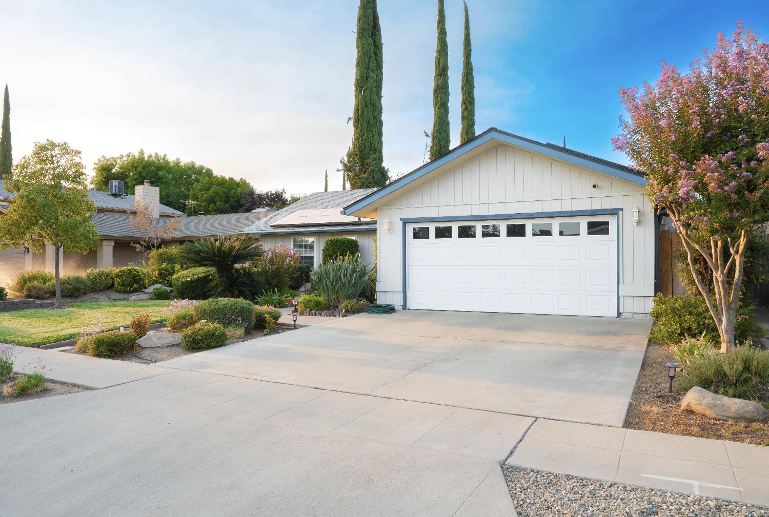 a view of spacious house with a yard and palm trees