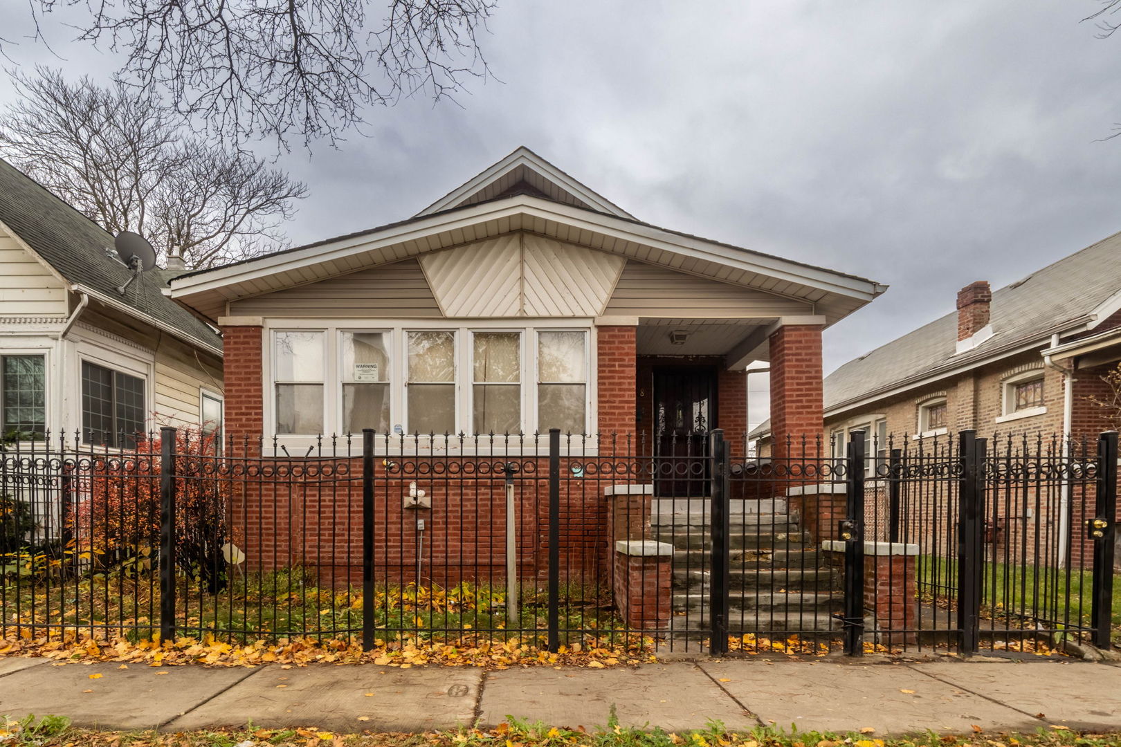 a front view of a house with a iron gate