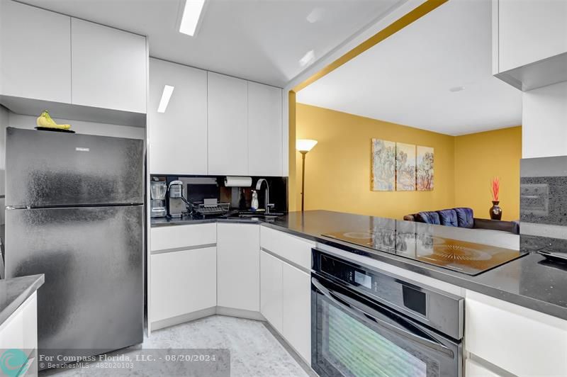 a kitchen with a sink and a refrigerator