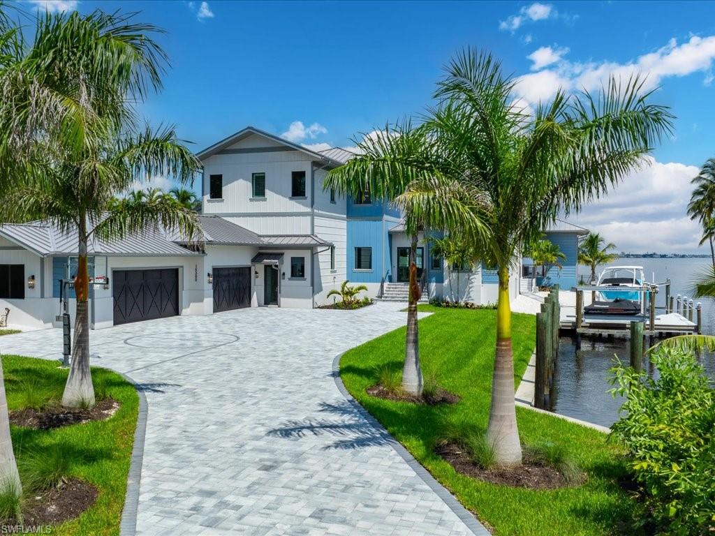 a front view of a house with garden and swimming pool