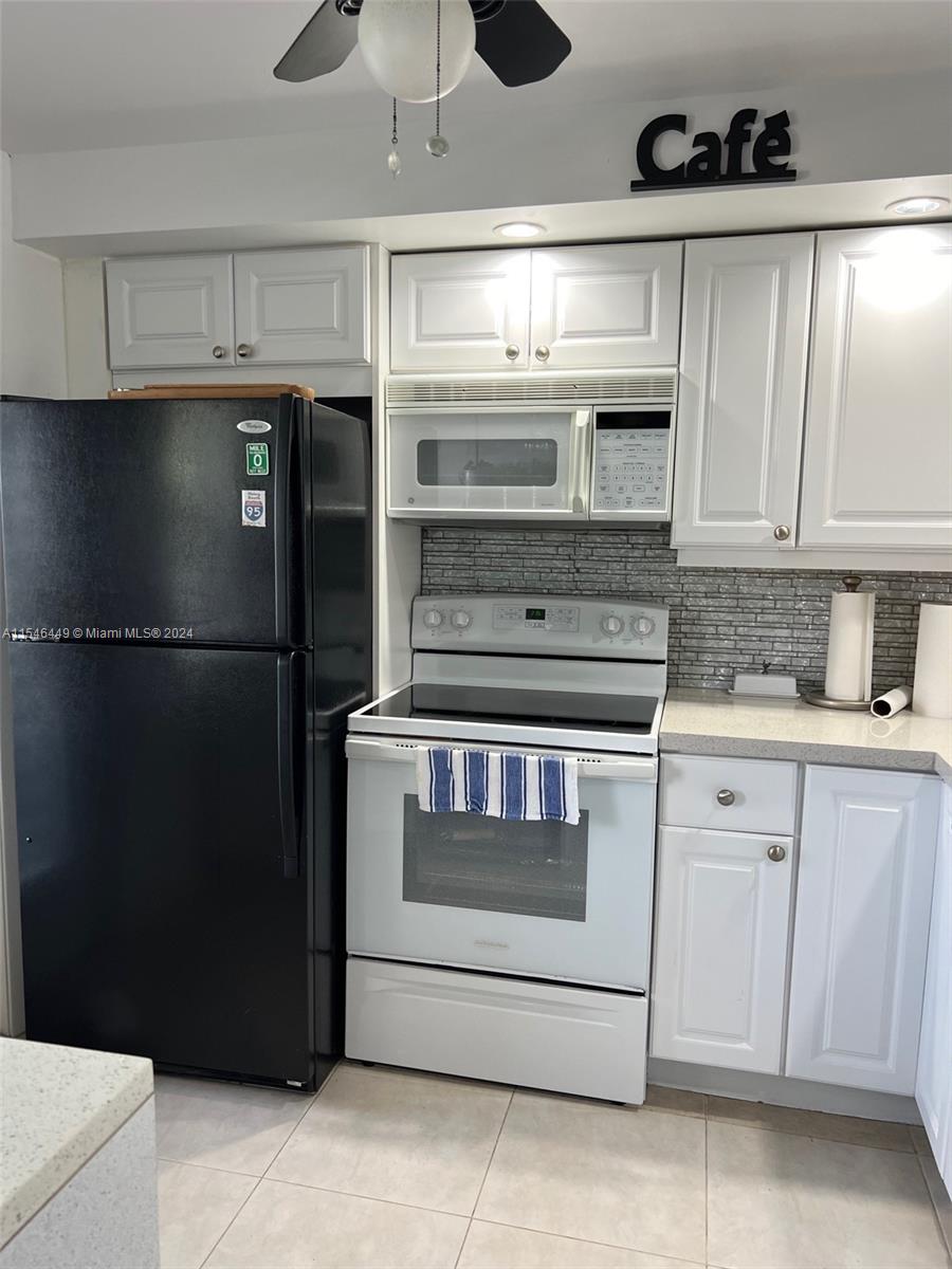 a kitchen with appliances and cabinets