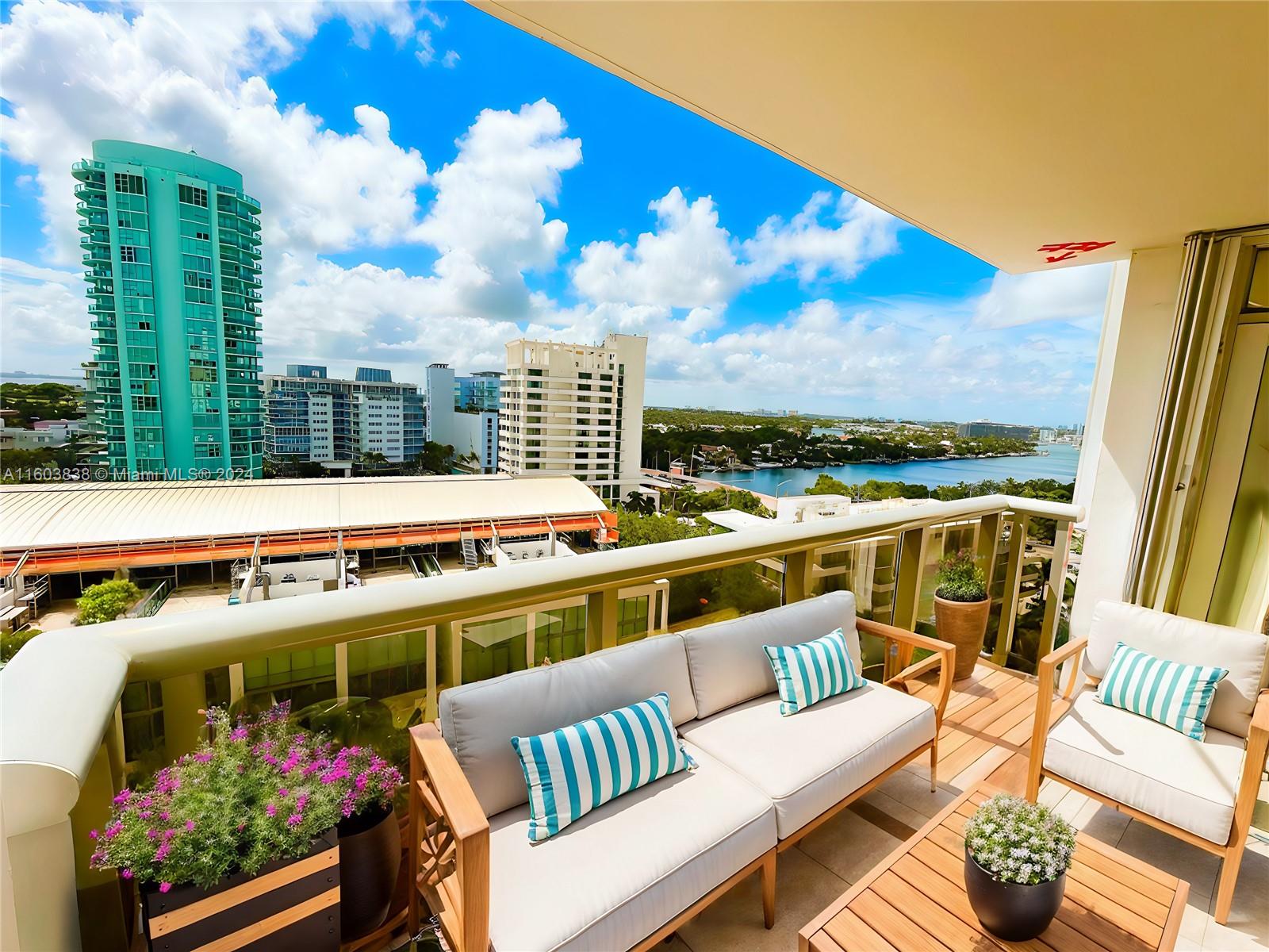 a view of a balcony with wooden floor and outdoor seating