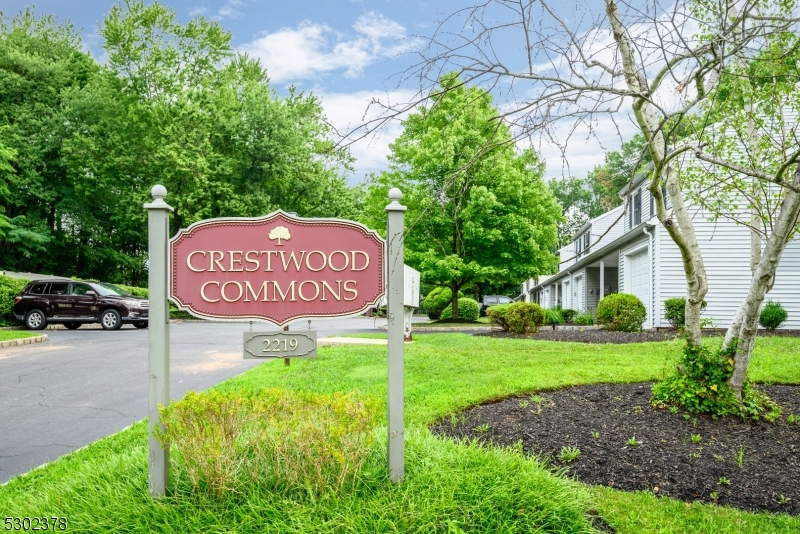 a sign board with a yard and green space