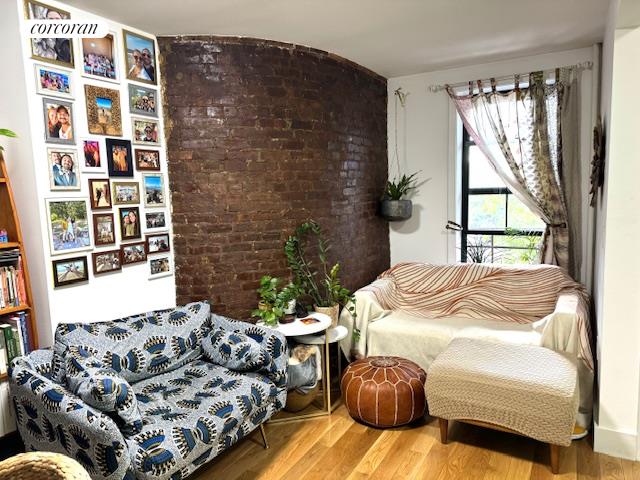 a bedroom with bed couch and window