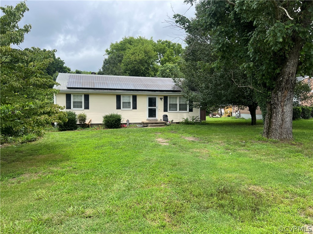 a view of a house with a yard and sitting area