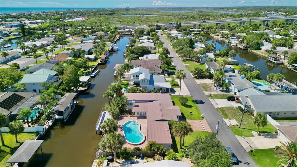 an aerial view of residential houses with outdoor space and lake view