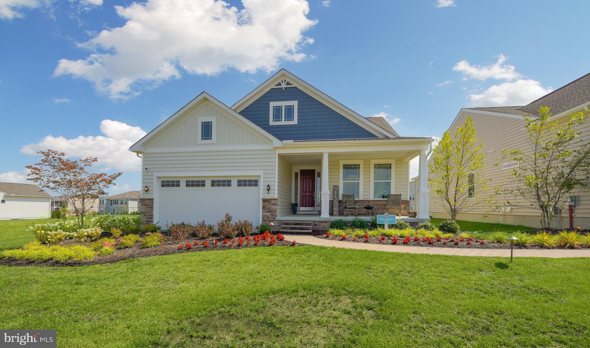 a front view of a house with a garden and plants