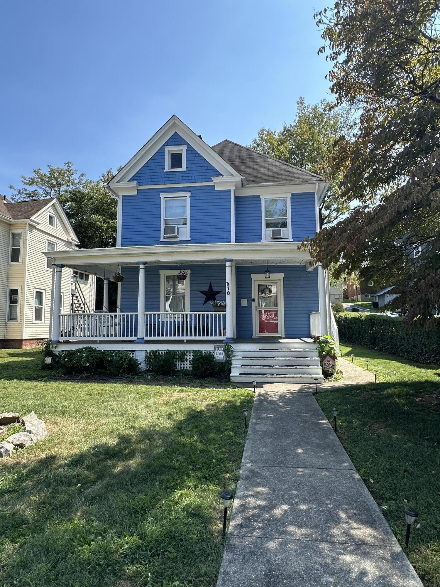 a view of house with a yard