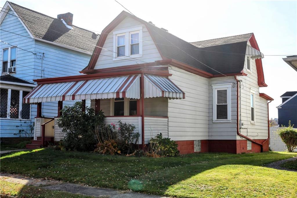 a front view of house with yard and green space