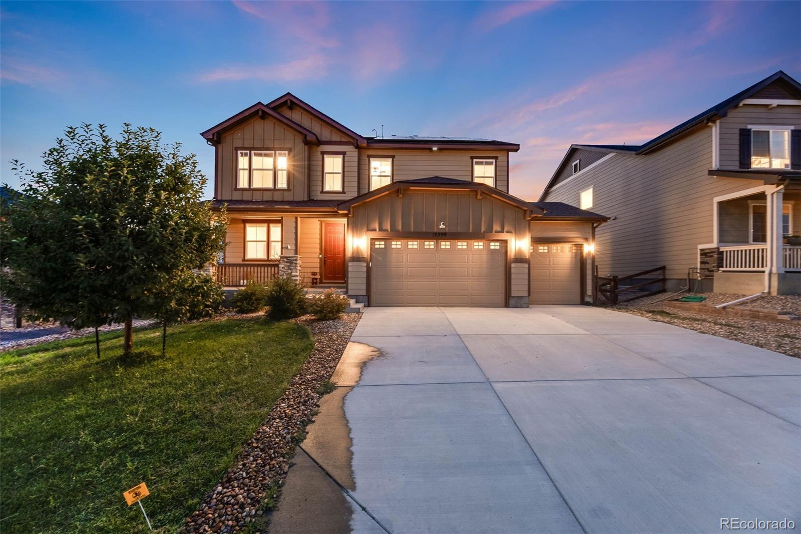 a front view of a house with a yard and garage