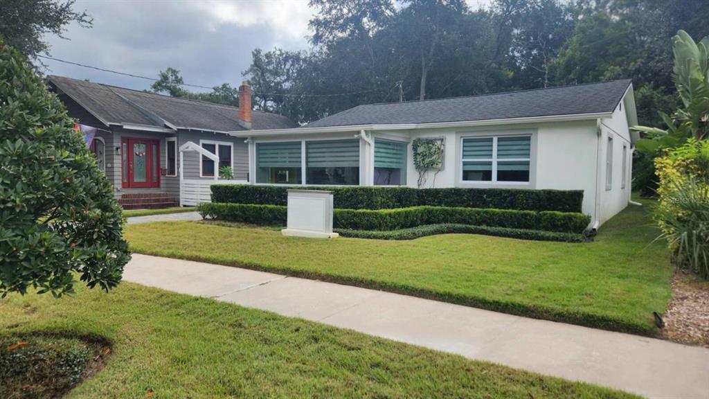 a front view of a house with a yard and porch