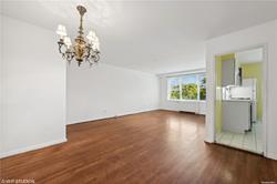 a view of a room with wooden floor and chandelier