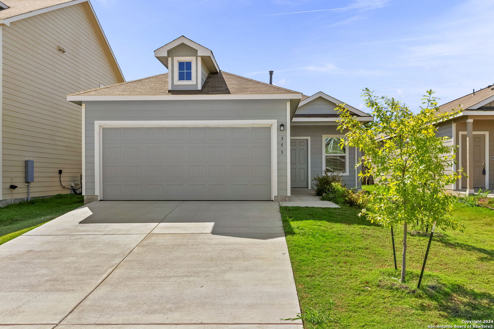 a front view of a house with a yard