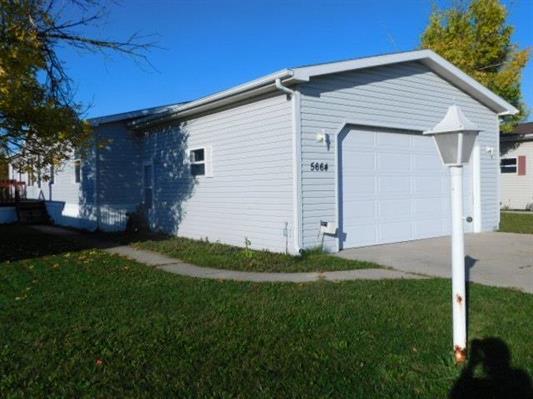 a front view of house with a garden