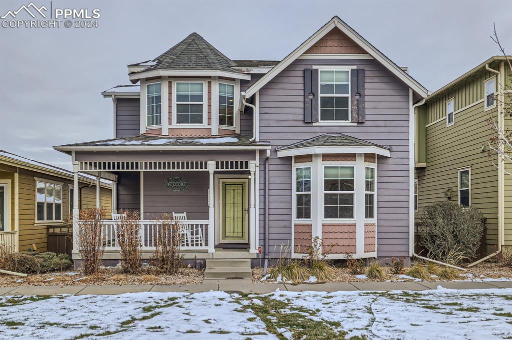 Victorian home featuring covered porch