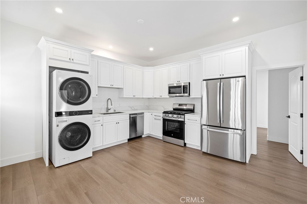 a kitchen with wooden cabinets and stainless steel appliances