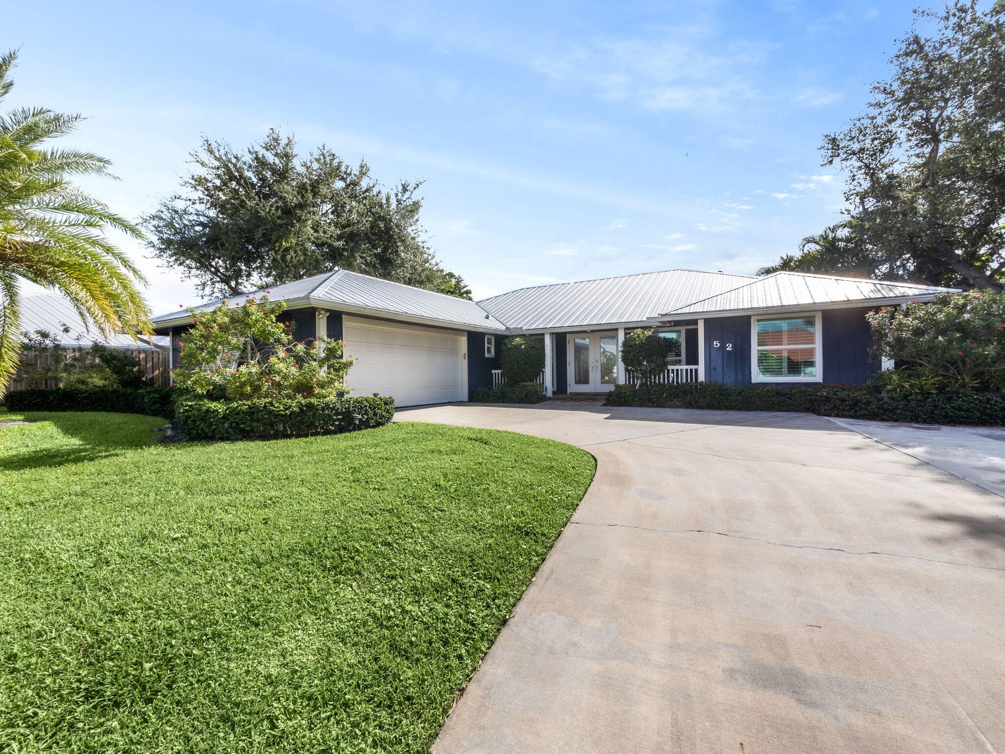 a front view of house with yard and green space