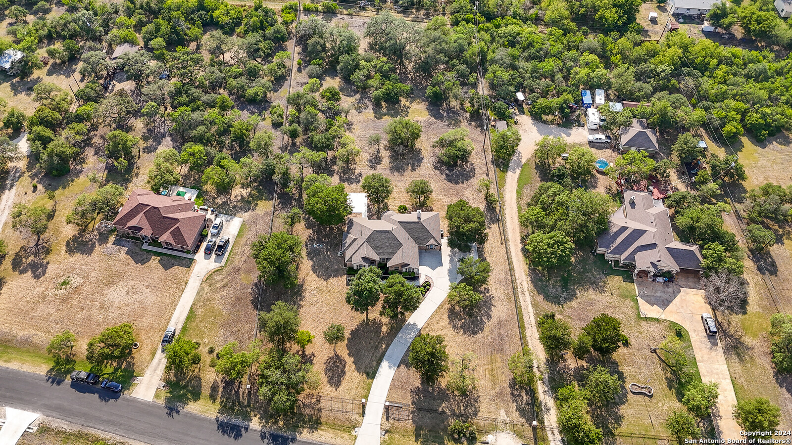 an aerial view of residential houses with outdoor space