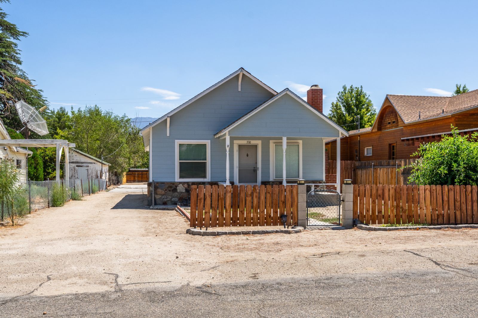 a view of a house with wooden fence