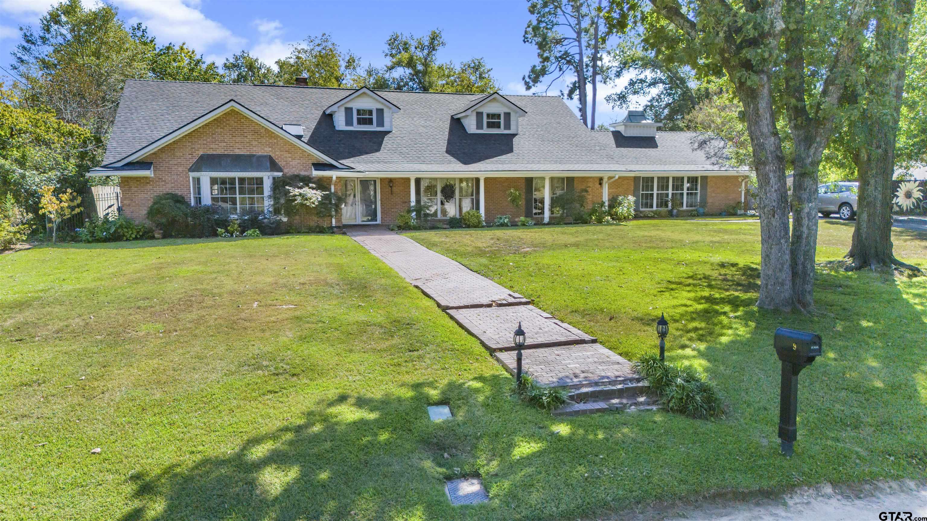 a front view of house with yard and green space