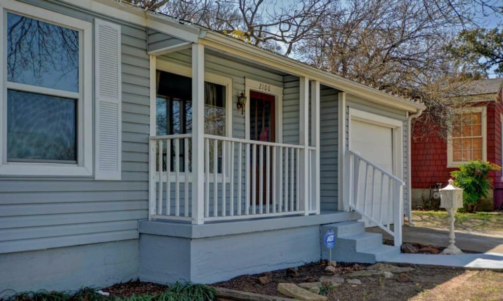 a view of a house with a small deck