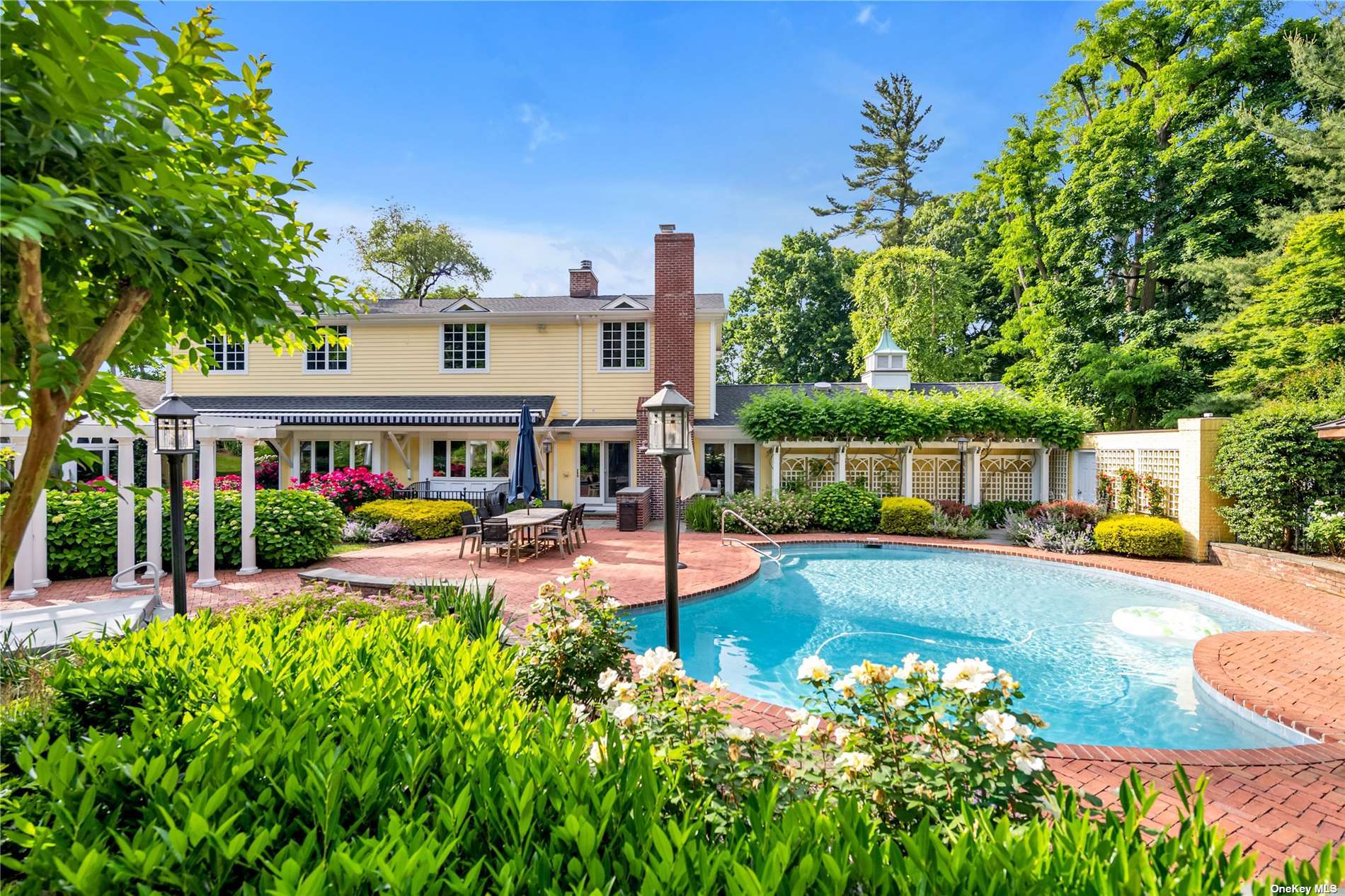 outdoor view of a house with swimming pool and sitting area