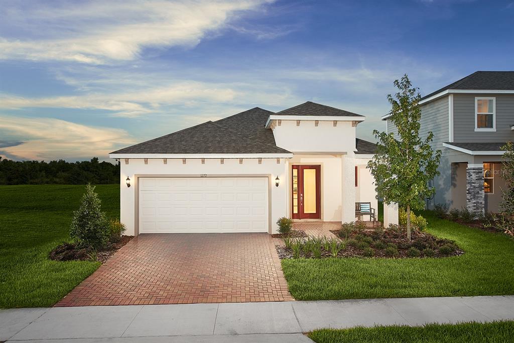 a front view of a house with a yard and garage