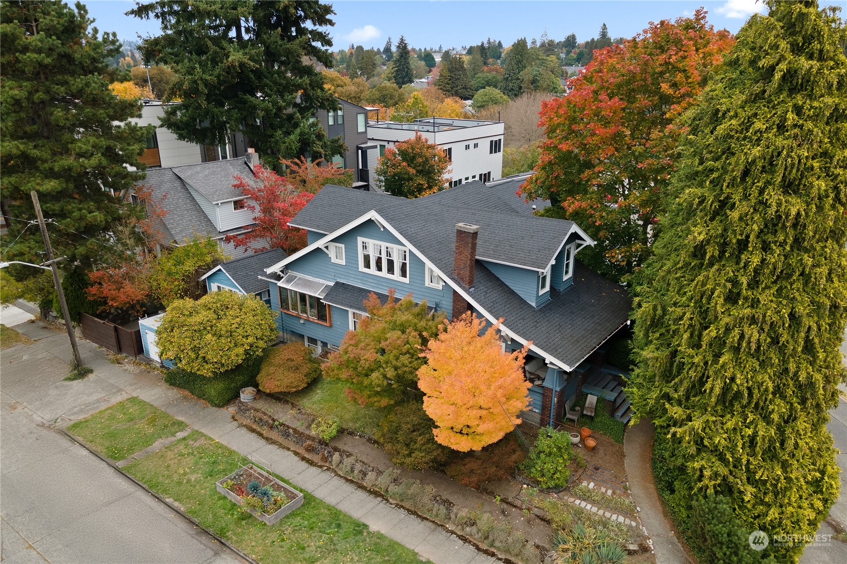 an aerial view of a house with garden space and street view