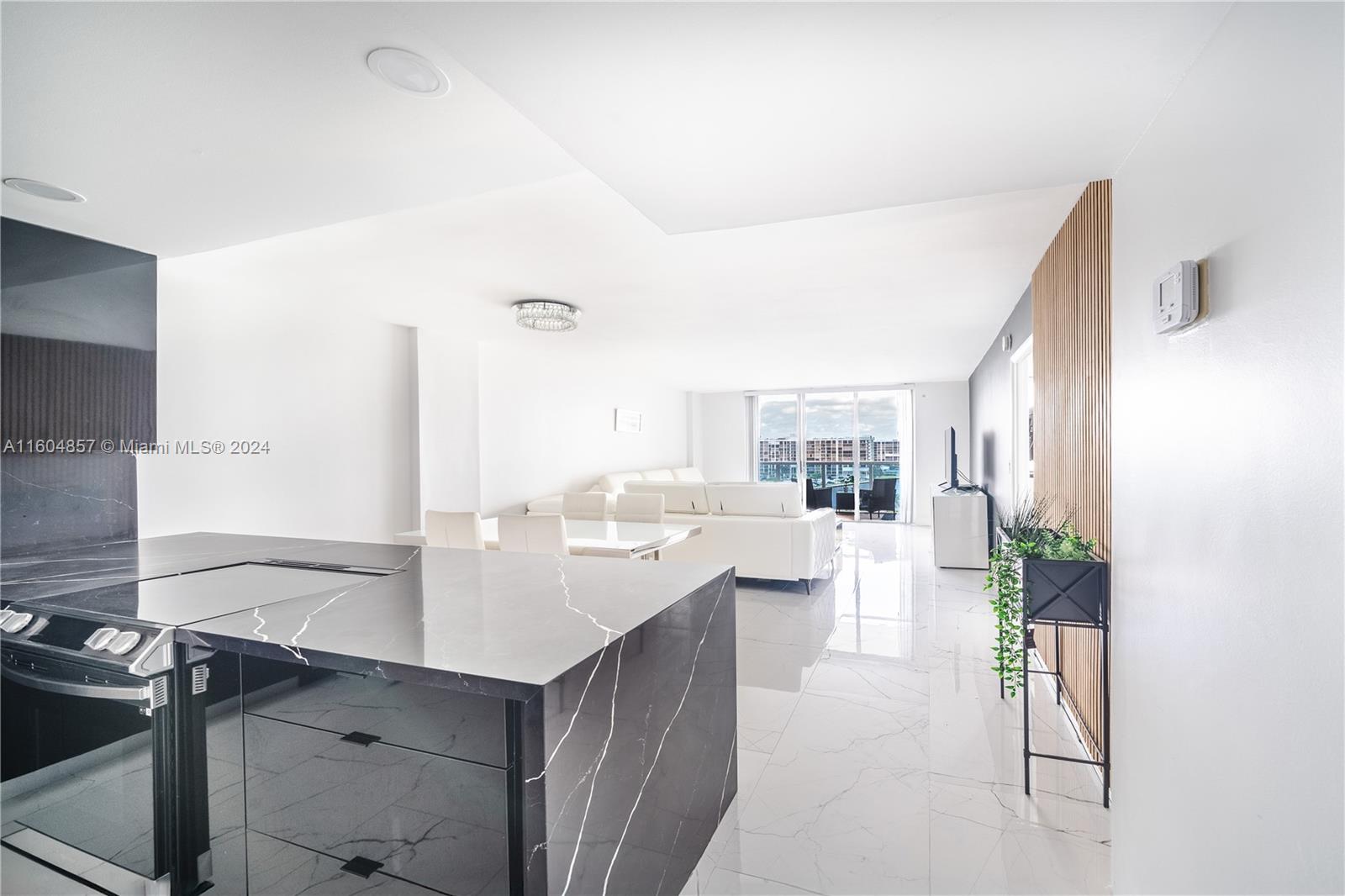 a kitchen with a sink and living room