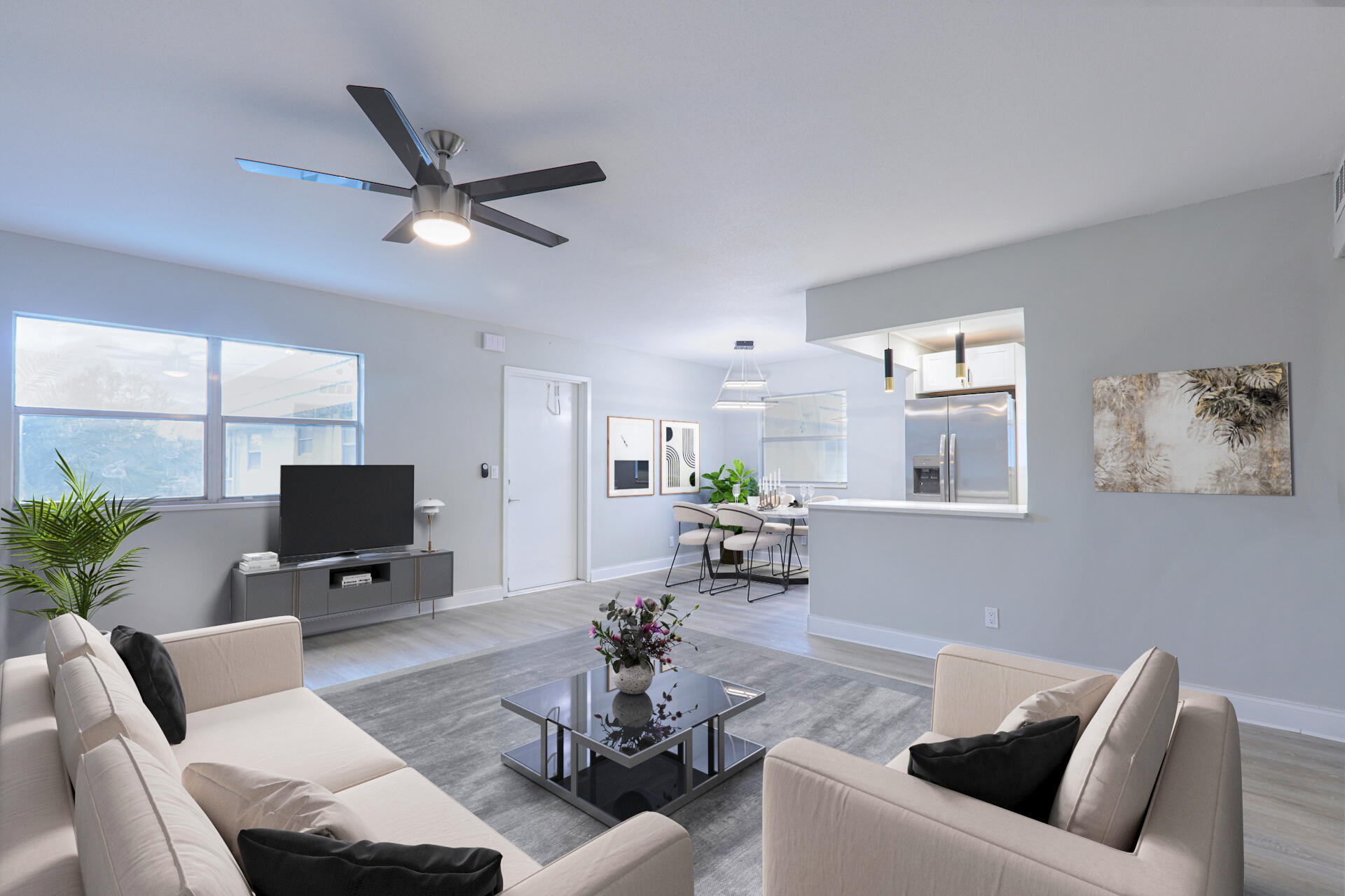 a living room with furniture a window and a flat screen tv