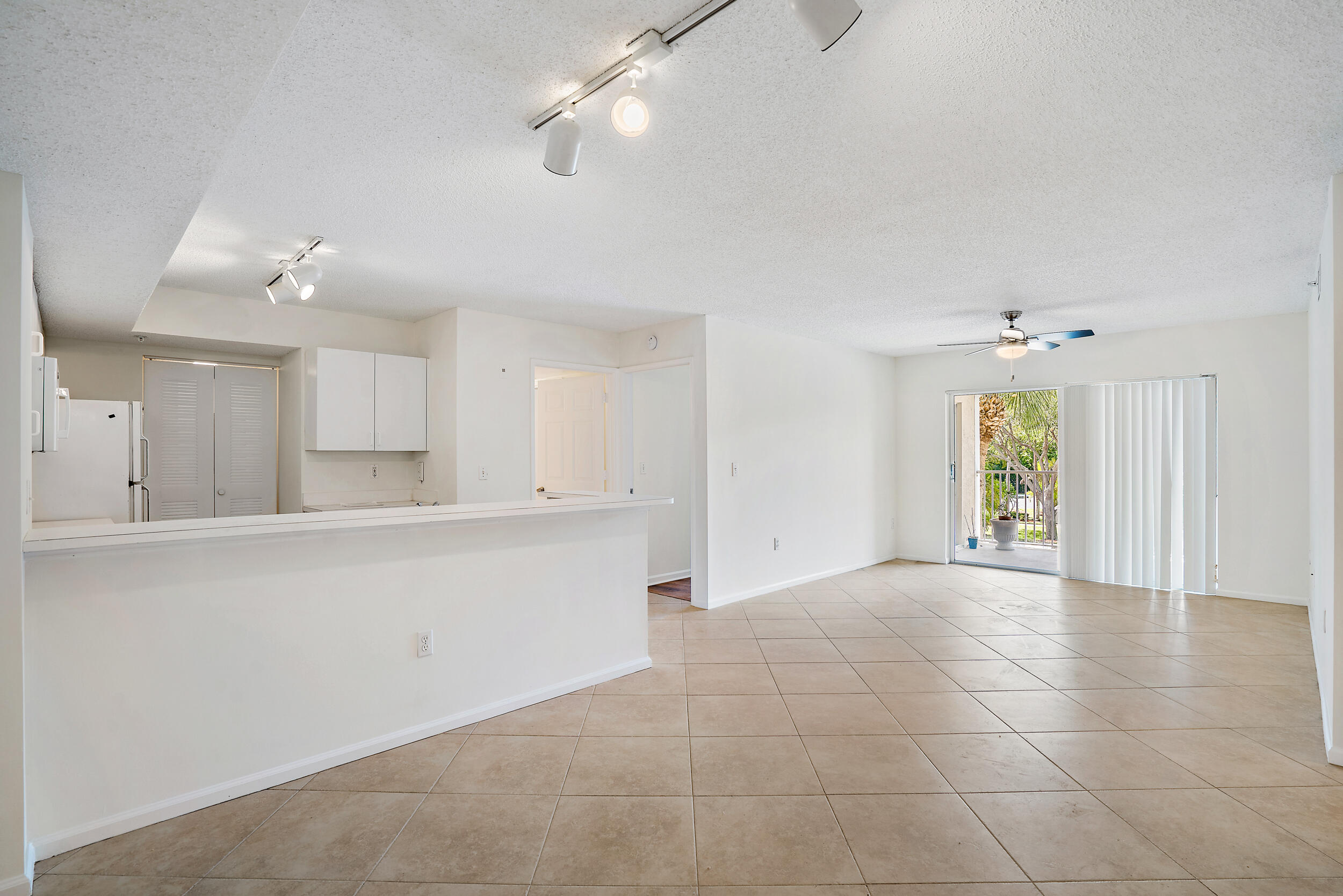 a view of a kitchen with furniture and a ceiling fan