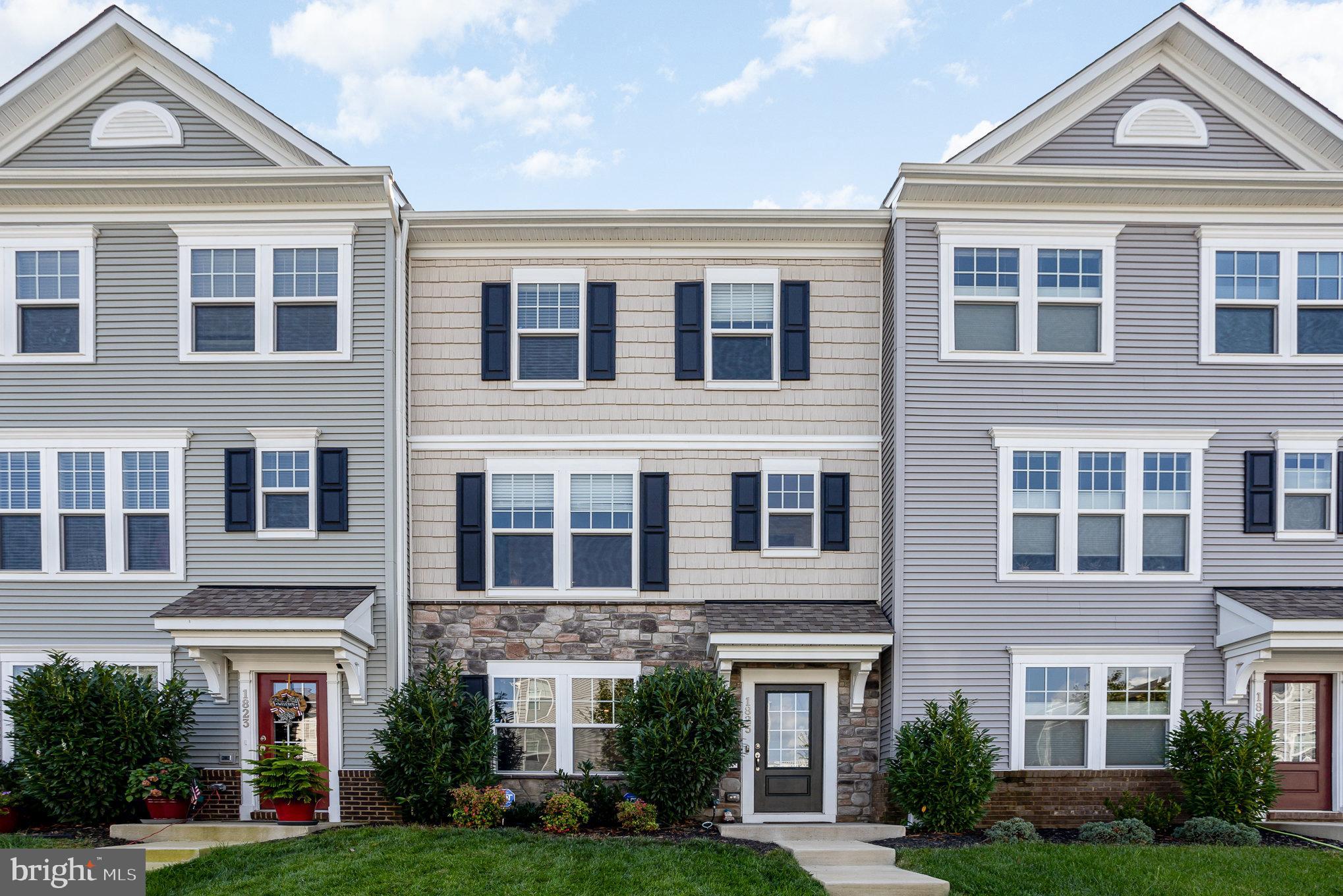 a front view of a residential apartment building with a yard