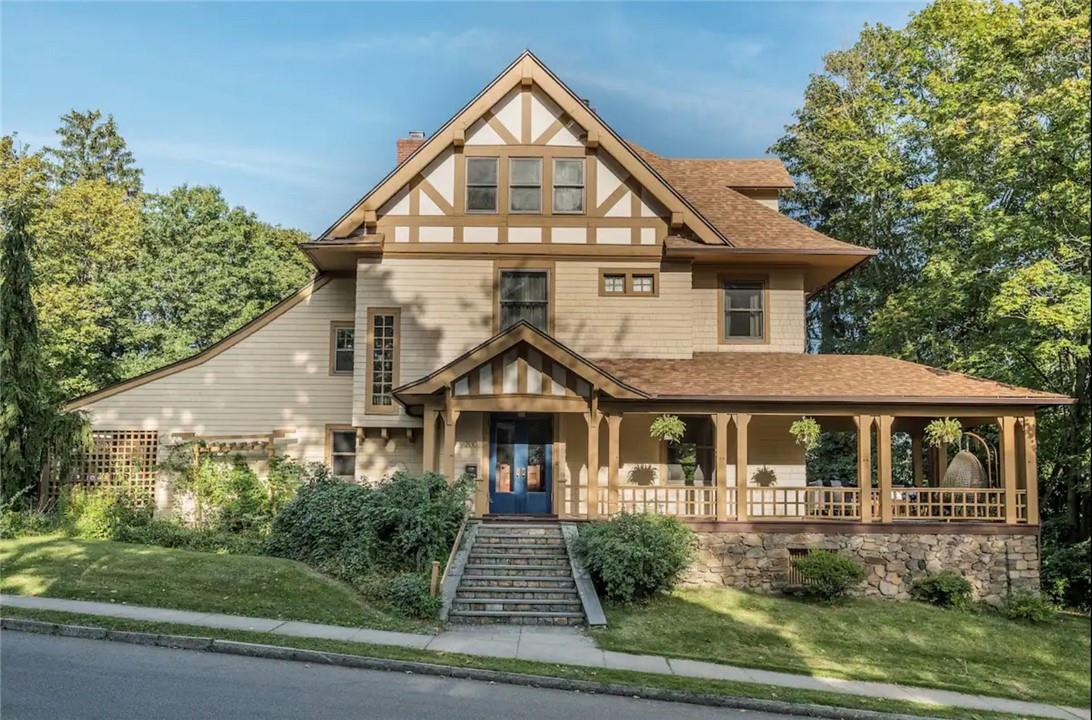 View of the front of the home showing the wraparound porch