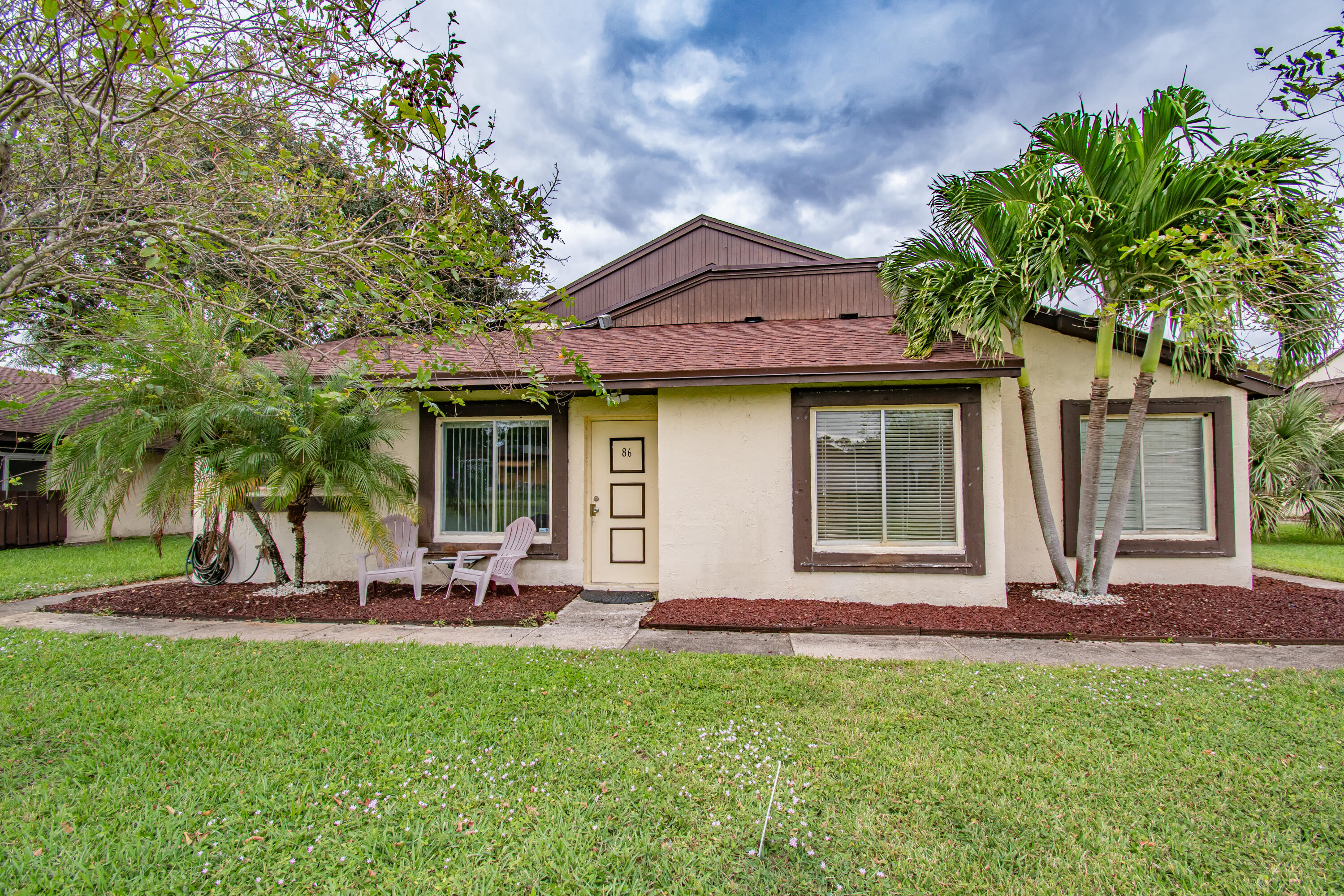 a front view of a house with garden