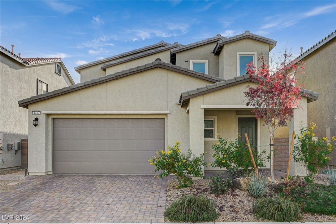 Exterior Front of home with desert landscape and n