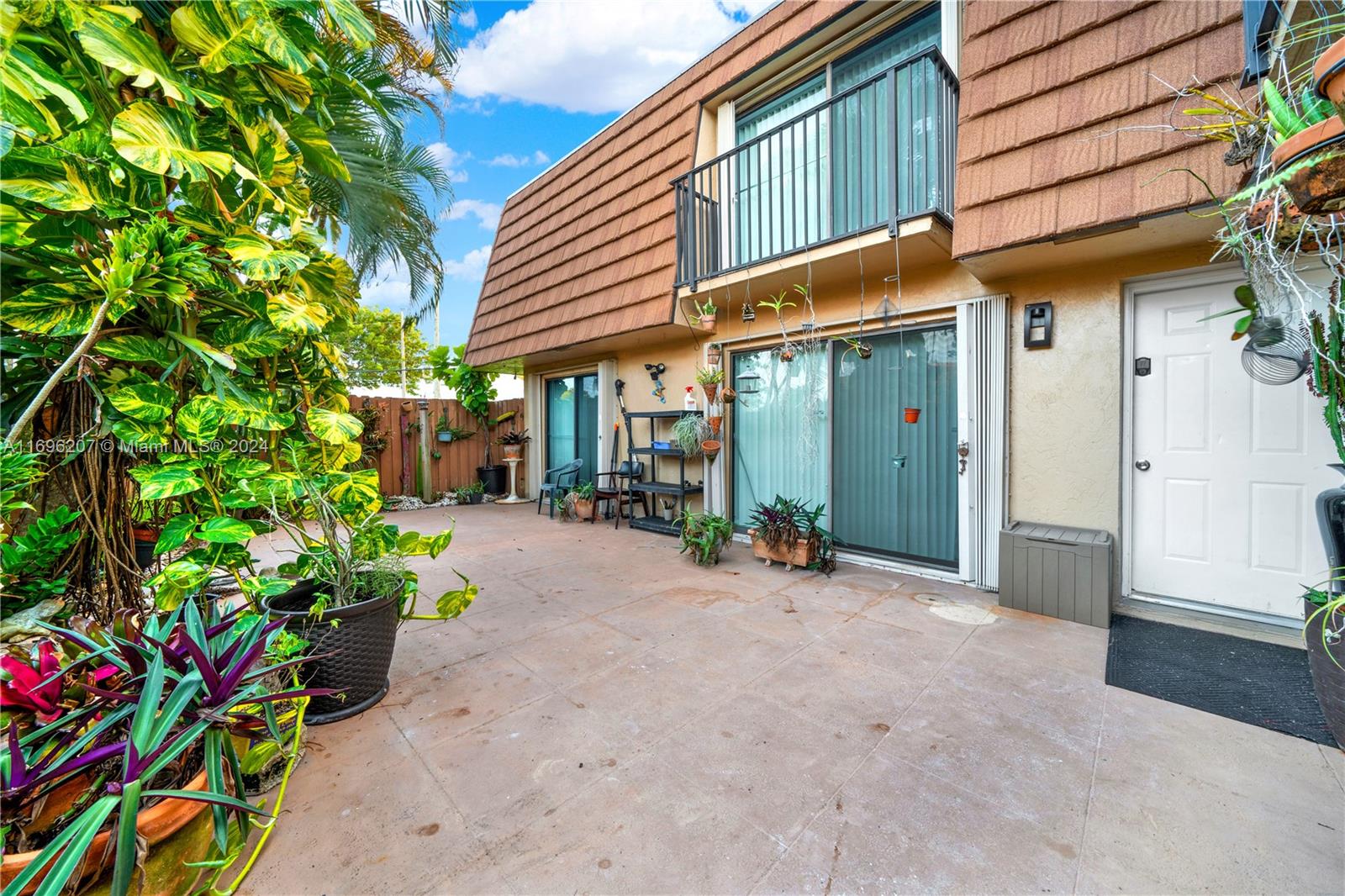 a view of a house with potted plants