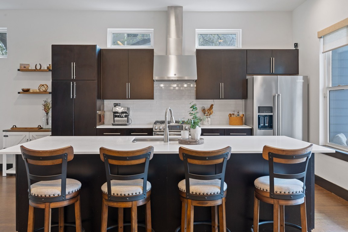 a kitchen with a table chairs and a refrigerator