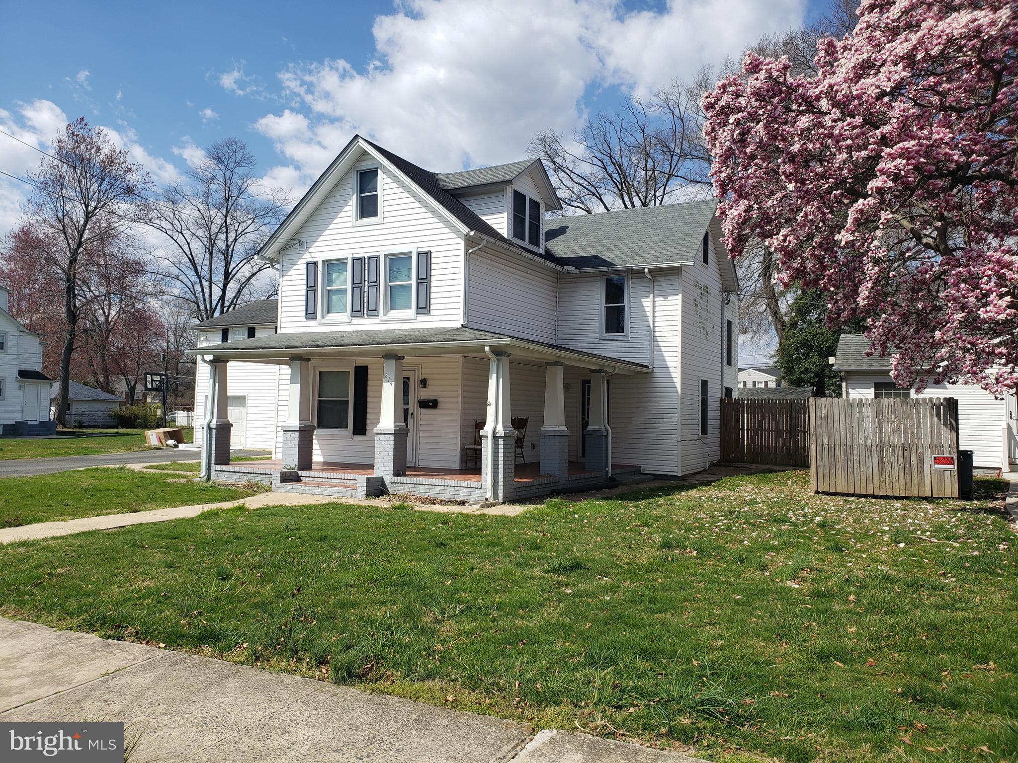 a front view of a house with a yard porch and sitting area