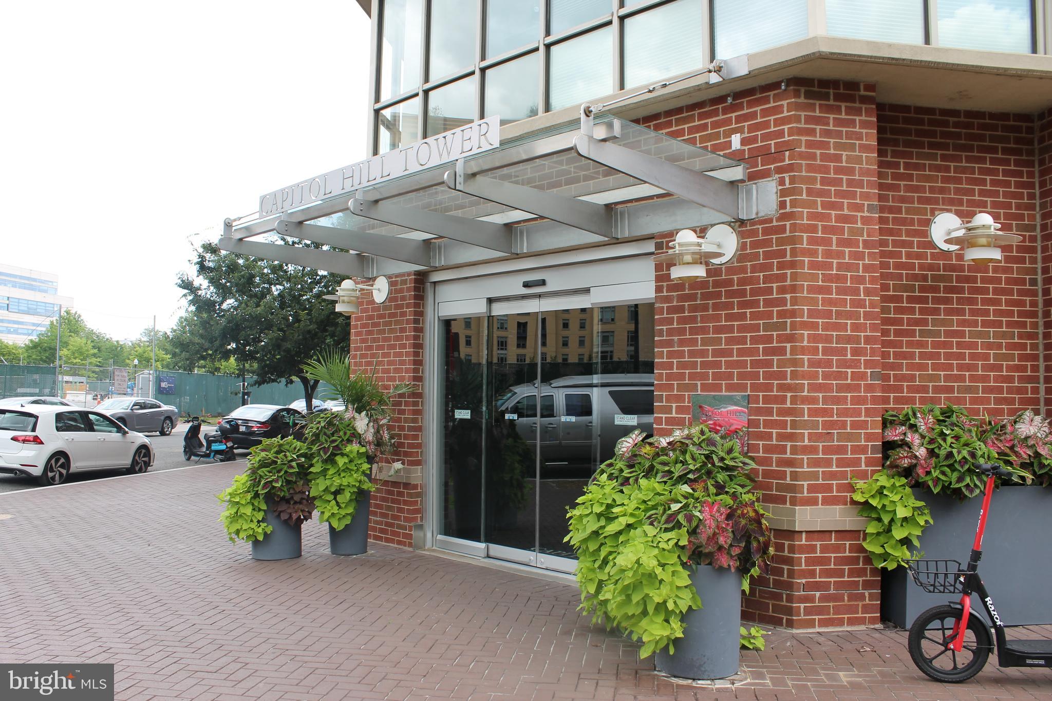 a front view of a house with potted plants