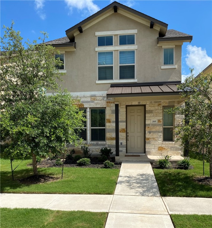 a front view of a house with a garden