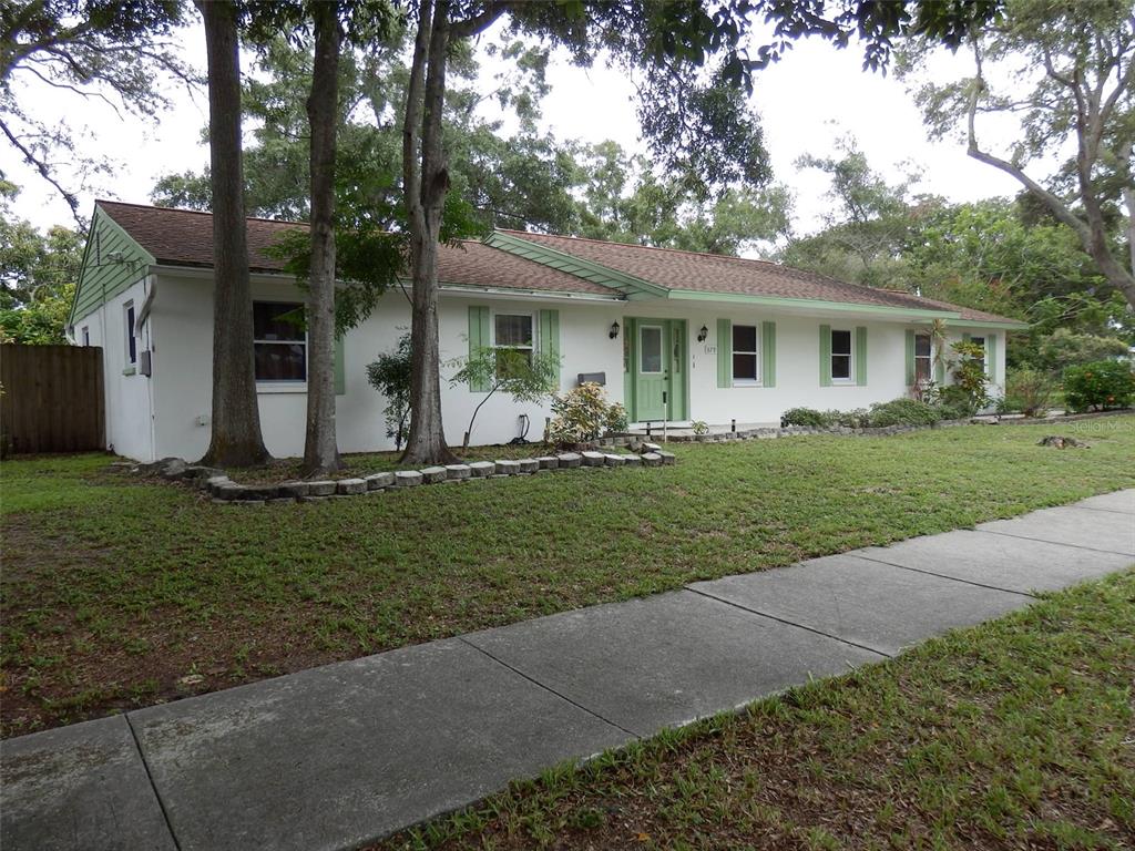 a front view of house with yard and green space