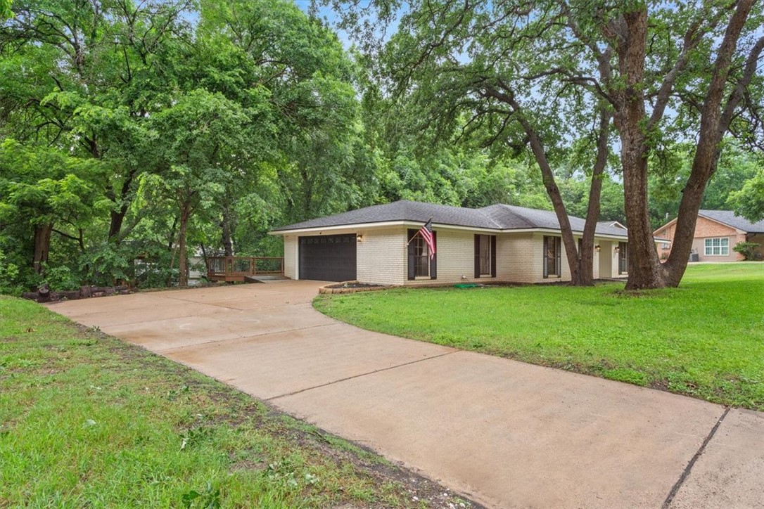 a front view of house with yard and green space