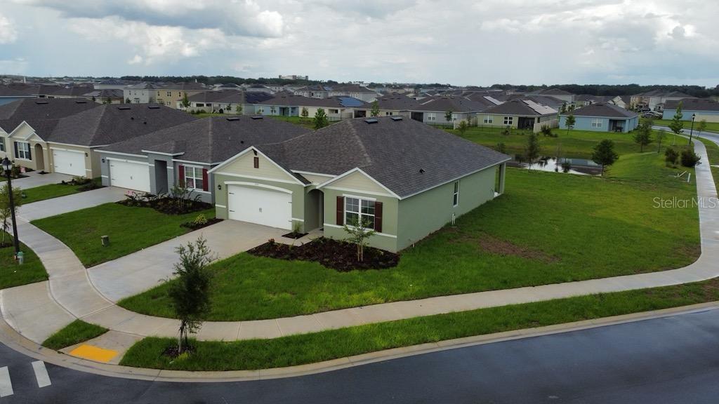 a aerial view of a house with a garden and trees