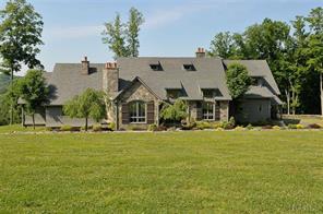 a front view of house with yard and trees