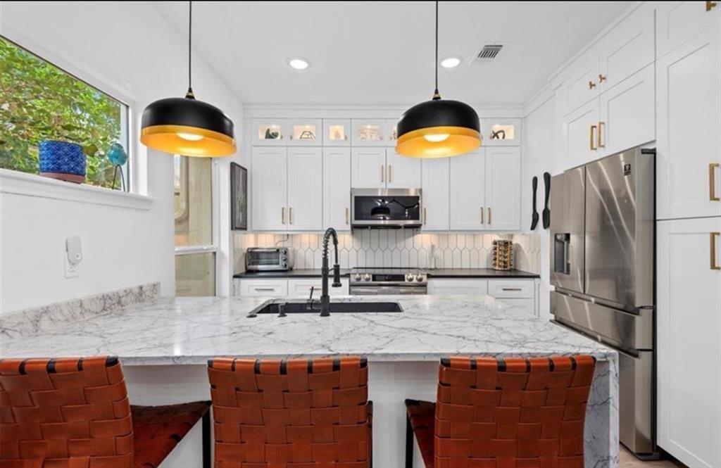 a kitchen with a stove and a refrigerator